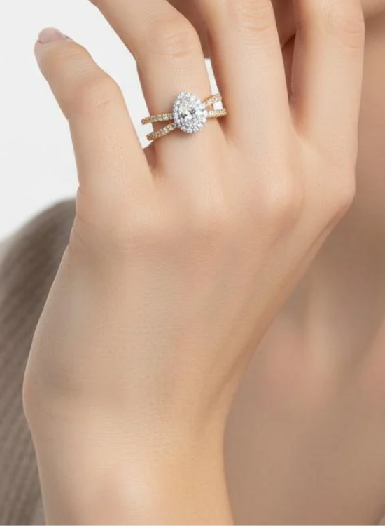 Two slender bands sweep upward toward the center stone, creating the distinctive open silhouette of this Split Shank Wedding Ring. The divided shank adds visual dimension while giving the design a